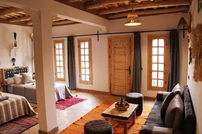 a living room with a couch and a table at Dar Mezyana Dades in Aït Idaïr