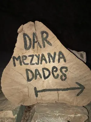 a log with the words dr neananarmaades written on it at Dar Mezyana Dades in Aït Idaïr