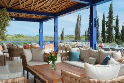 a patio at a restaurant with tables and chairs at Le Clos des Oliviers in Oulad Jellal