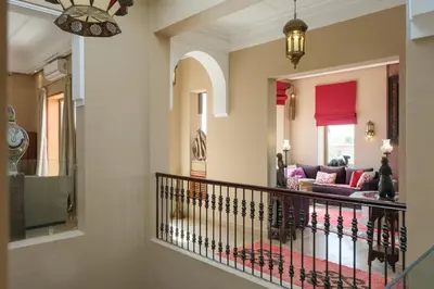 a hallway of a home with a staircase and a living room at Le Clos des Oliviers in Oulad Jellal