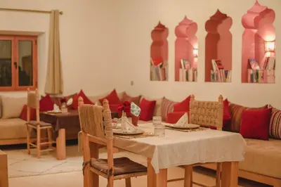 a dining room with a table and a couch at AdaZen Ecolodge - Ait Bouguemez in Azilal