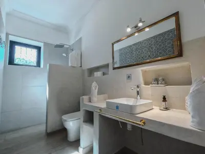 a bathroom with a sink and a toilet and a mirror at AdaZen Ecolodge - Ait Bouguemez in Azilal