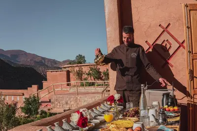 a man standing in front of a table of food at AdaZen Ecolodge - Ait Bouguemez in Azilal
