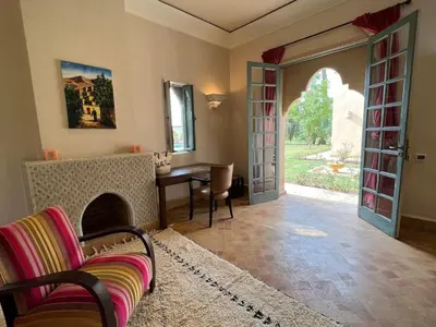 a living room with a couch and an open door at Privat Villa in Marrakesch with Pool & Garten in Marrakech