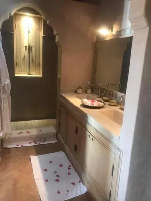 a bathroom with a sink and a mirror at Privat Villa in Marrakesch with Pool & Garten in Marrakech