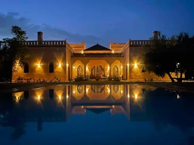 a building with a swimming pool at night at Privat Villa in Marrakesch with Pool & Garten in Marrakech