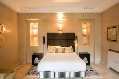 a bedroom with a large white bed in a room at Dar Neylla in Douar Caïd Layadi