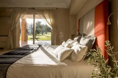 a bedroom with a large bed with white pillows at Dar Neylla in Douar Caïd Layadi