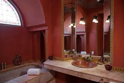 a bathroom with two sinks and a large mirror at Ame-Za in Douar Soukkane