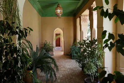 an empty hallway with plants and a chandelier at Ame-Za in Douar Soukkane