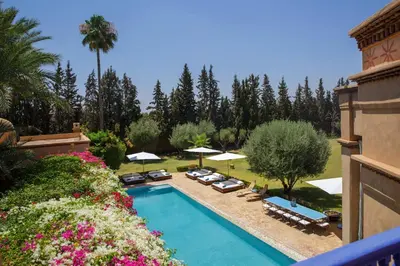 an overhead view of a swimming pool with chairs and umbrellas at Ame-Za in Douar Soukkane