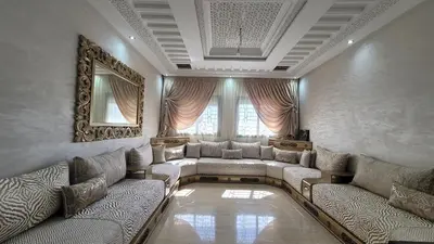 a large living room with couches and a mirror at ZR Comfort in Fès