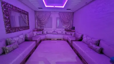 a purple room with purple couches and curtains at ZR Comfort in Fès