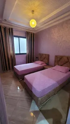 a room with two beds and a window at ZR Comfort in Fès