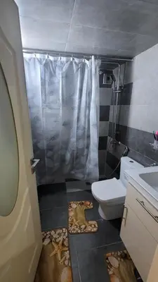 a bathroom with a toilet and a shower and a sink at ZR Comfort in Fès