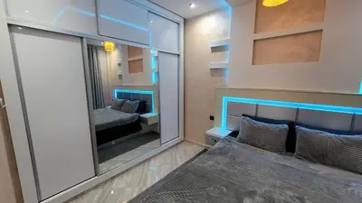 a room with a mirror and a bed in a room at ZR Comfort in Fès