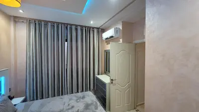 a bedroom with a bed and a television on the wall at ZR Comfort in Fès