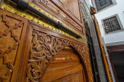 a wooden door with an ornate carving on it at Riad Pacha Palace in Fès