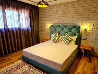a bedroom with a large bed with two pillows on it at Maurice Bonjean in Ifrane