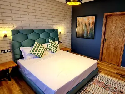 a bedroom with a large bed with blue walls at Maurice Bonjean in Ifrane
