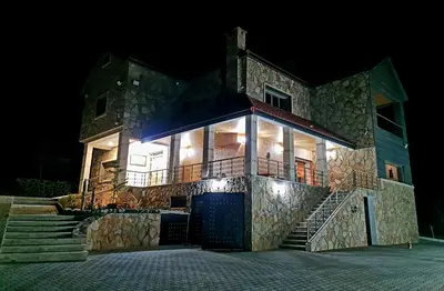 a large stone house at night with lights at Maurice Bonjean in Ifrane