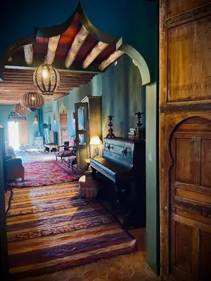 a living room with a grand piano in a room at Aux portes de Marrakech Villa Arts & Déco avec piscine in Marrakech