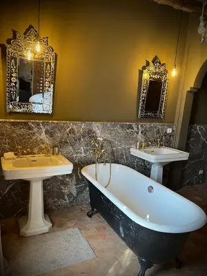 a bathroom with two sinks and a bathtub and a bath tub at Aux portes de Marrakech Villa Arts & Déco avec piscine in Marrakech
