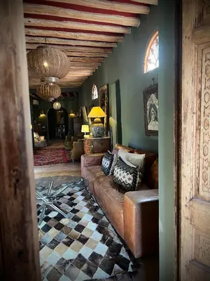 a living room with a couch and a checkered floor at Aux portes de Marrakech Villa Arts & Déco avec piscine in Marrakech