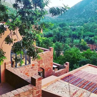 a stone house with a view of a mountain at Boutique Guesthouse Dar Zohra in Marrakech