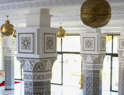 a room with columns and a ball on the ceiling at kasbah yu palace in Ouarzazate