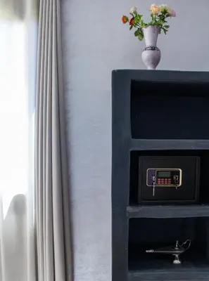 a black safe with a vase with flowers in it at kasbah yu palace in Ouarzazate