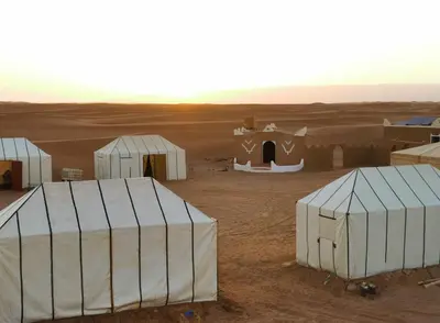 a group of tents in the middle of a desert at Bivouac Erg Chegaga Nomademoi in El Gouera
