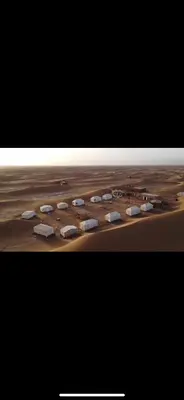 a view of a desert with a group of buildings at Bivouac Erg Chegaga Nomademoi in El Gouera