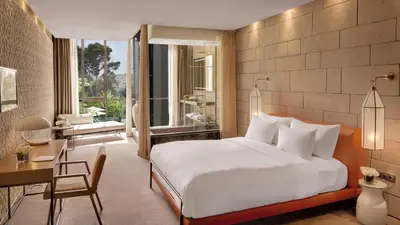 a bedroom with a large bed and a desk and a desk at Hotel Sahrai in Fès