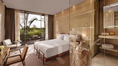 a hotel room with a bed and a desk and a table at Hotel Sahrai in Fès