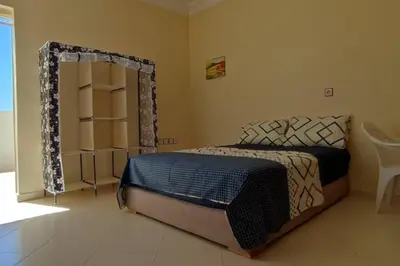 a bedroom with a bed and a mirror at Studio @khémisset in Khemisset