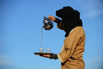 a man with a gas mask on his face looking at a machine at Desert Backpackers Camp in Merzouga