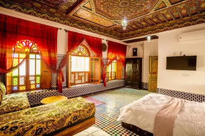 a room with a bed and a ceiling with a tv at Riad Sayeda Al Hora in Fès