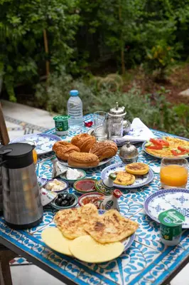 a blue and white table topped with plates of food at Riad Fez Mahal in Fès