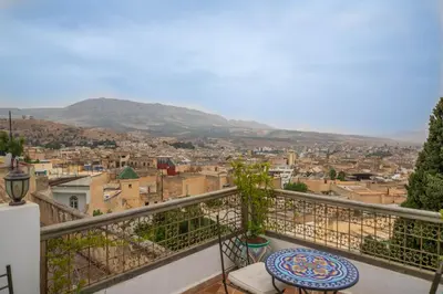 a balcony with a view of a city at Riad Fez Mahal in Fès