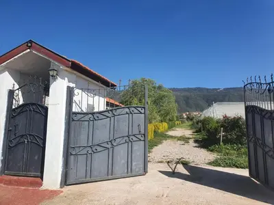 a pair of gates on the side of a house at Joli Chalet dans une ferme Pour familles exclusivement près ifrane in Azrou