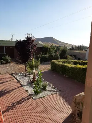 a brick walkway with plants in a yard at Joli Chalet dans une ferme Pour familles exclusivement près ifrane in Azrou