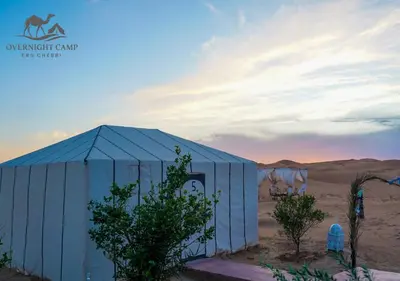 a blue building in the middle of the desert at Overnight Camp Erg Chebbi in Merzouga