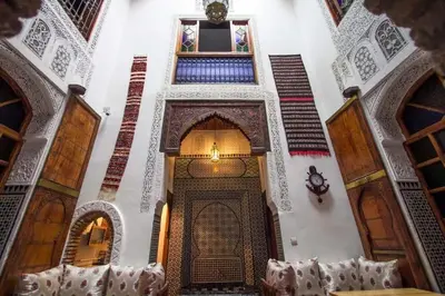 a hallway of a building with a door and windows at dar Benfares rcif in Fès