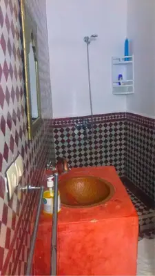 a bathroom with a orange sink in a room at dar Benfares rcif in Fès