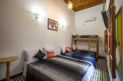 a bedroom with a bed and a bunk bed at dar Benfares rcif in Fès