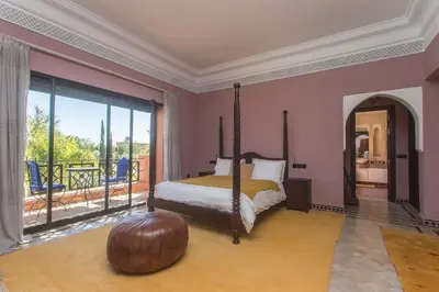 a bedroom with a bed and a large window at La Villa Rose Anna in Marrakech