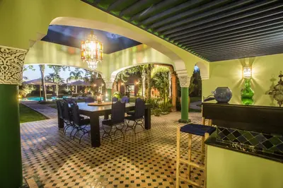 a dining room with a table and chairs in a house at La Villa Rose Anna in Marrakech