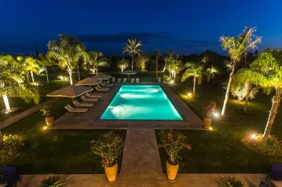an overhead view of a swimming pool at night at La Villa Rose Anna in Marrakech