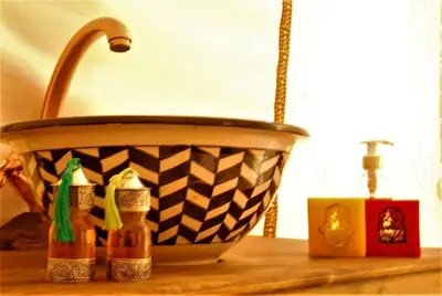 a basket and some bottles on a wooden table at Merzouga Bohemian Camp in Merzouga